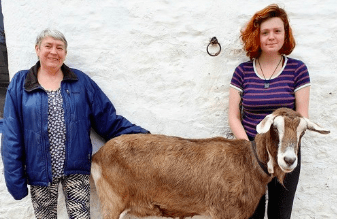 Juanita Wilson MBE and her new staff member Beth Black, and a goat